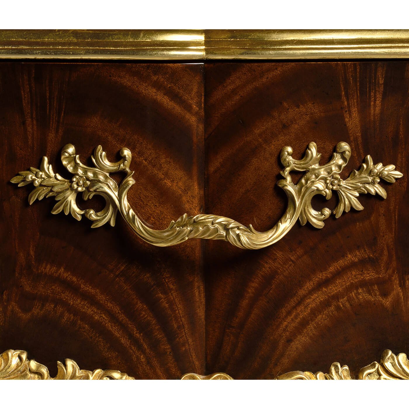 Gilt handle on rococo nightstand drawer.