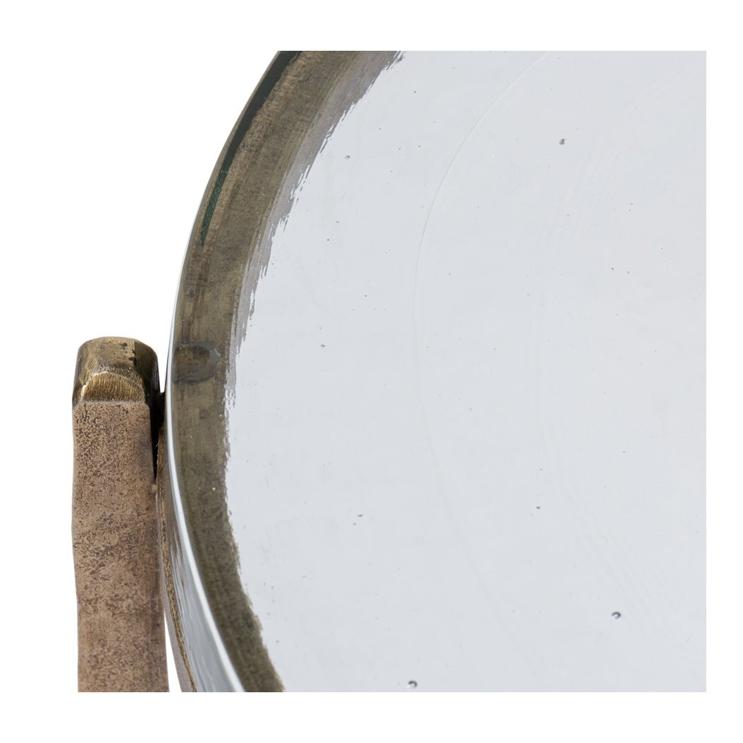 Close-up of edge detail on round glass accent table.