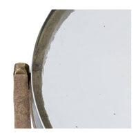 Close-up of edge detail on round glass accent table.