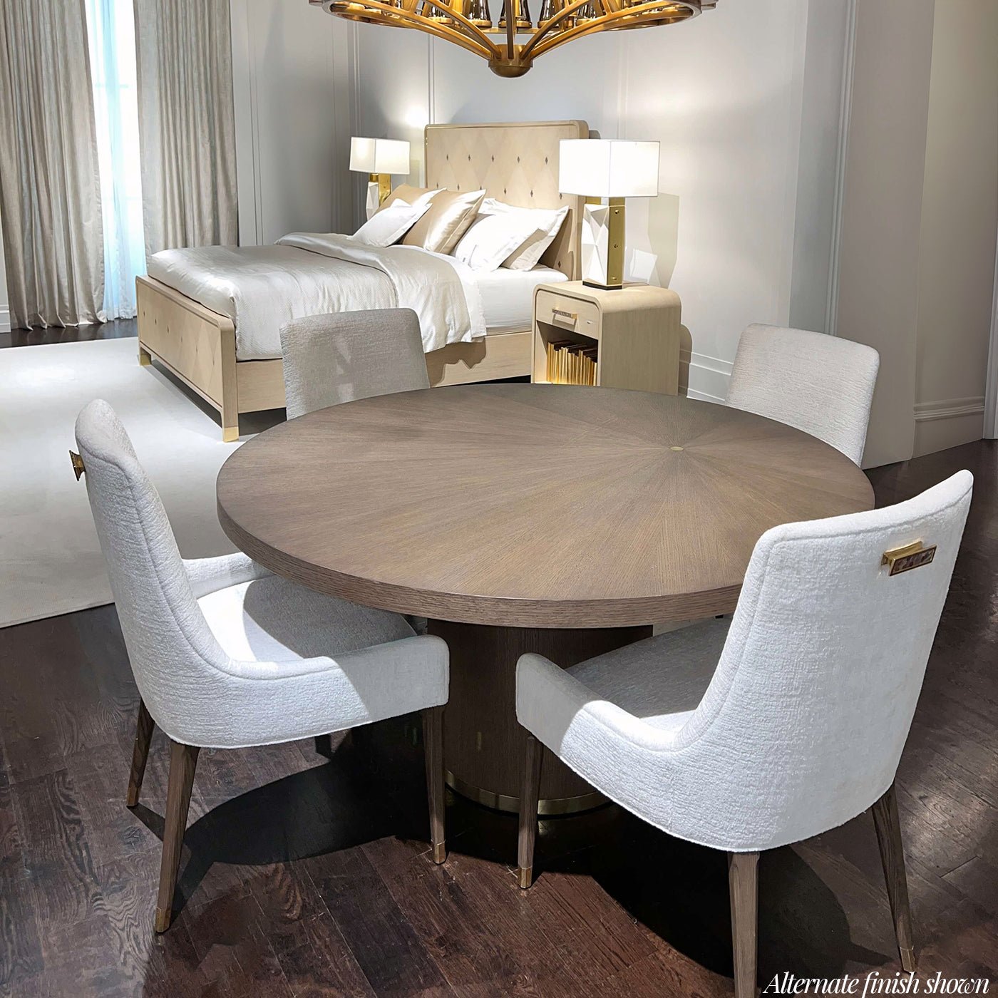 Dark wood finish round dining table in bedroom setting.