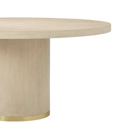 Cylindrical base with gold detailing on dining table.