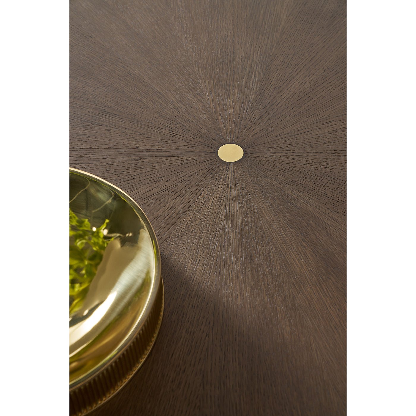 Detail of dark mink dining table's center gold accent.