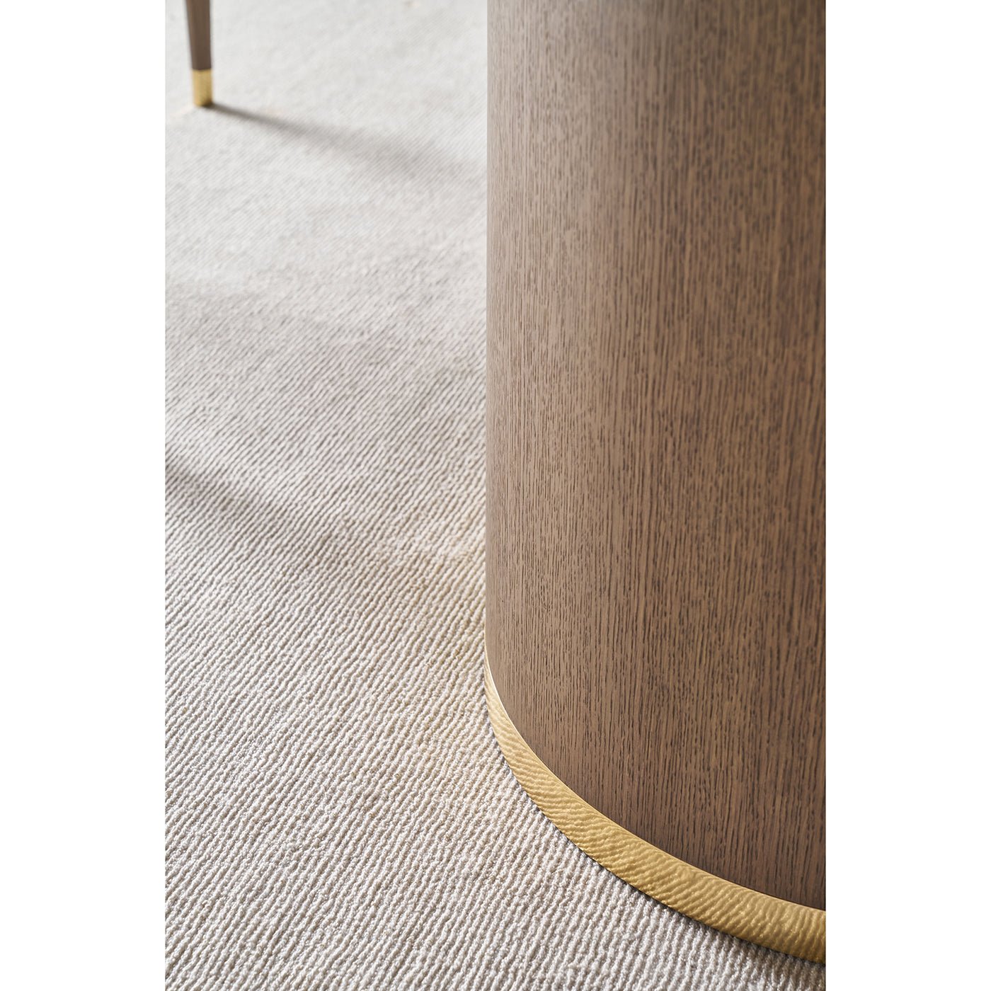 Close-up of dark mink table base with gold accent.