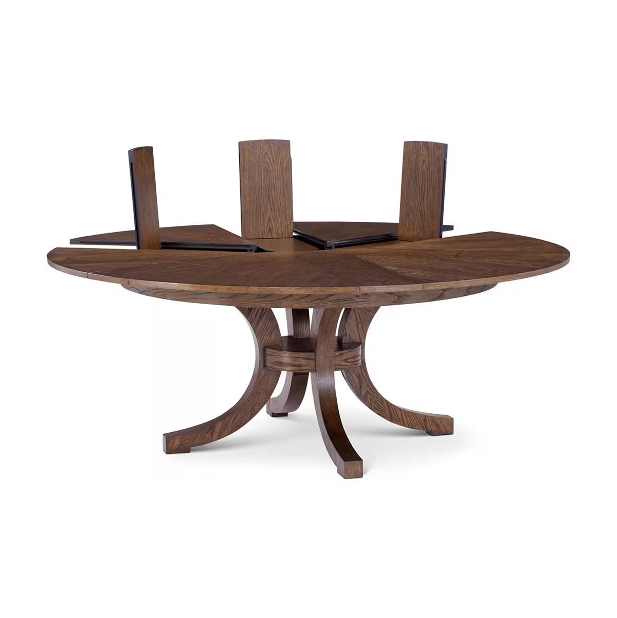 Round oak dining table with extended leaf inserts.