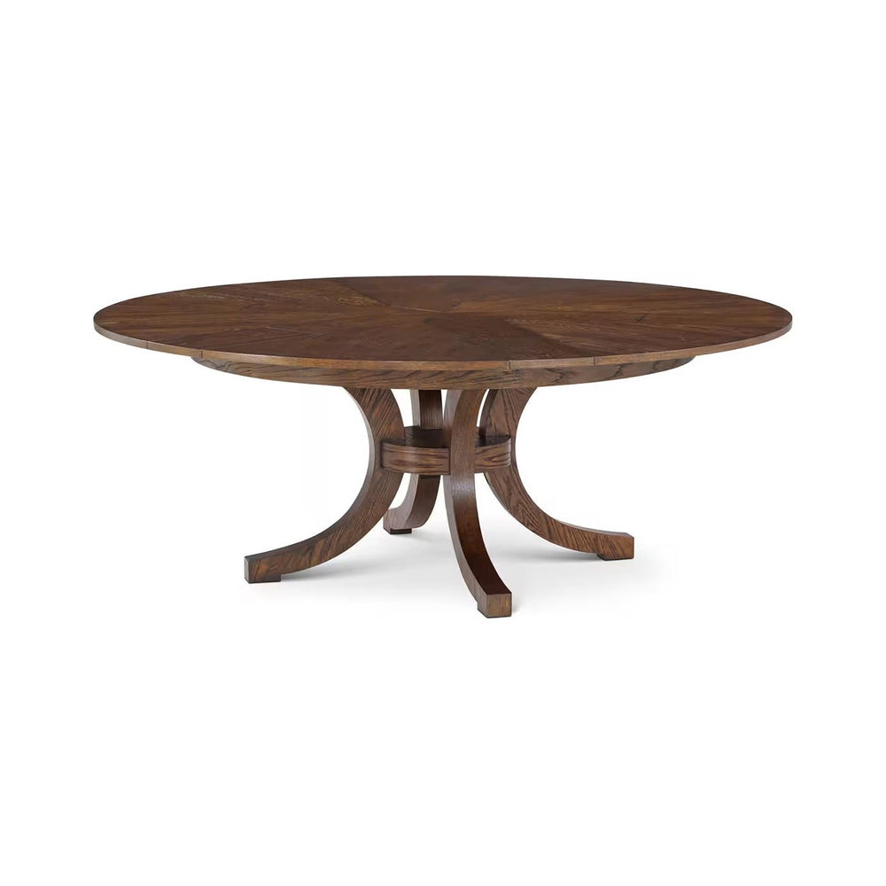 Round oak dining table with pedestal base, top view.