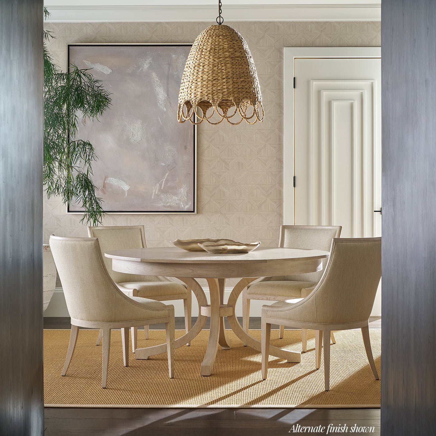 Round oak dining table in elegantly decorated dining room.