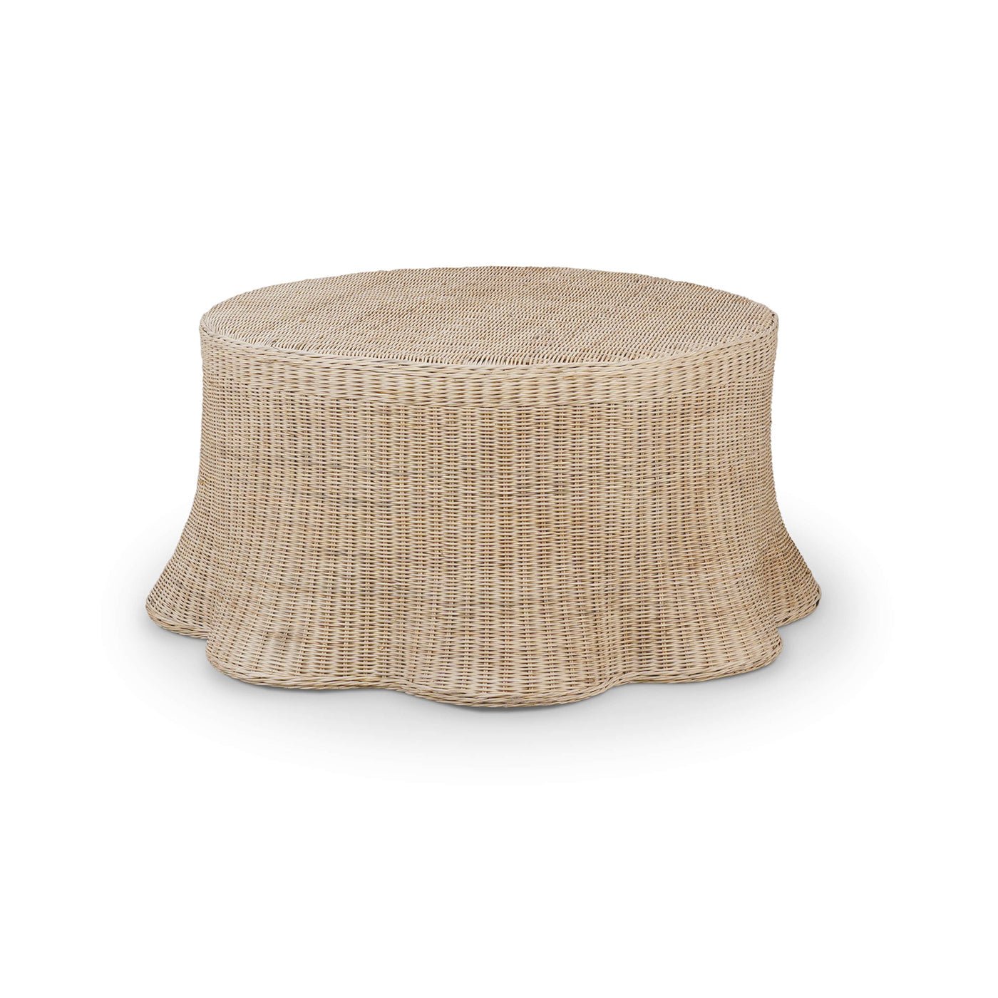 Round rattan coffee table with flared skirt design.