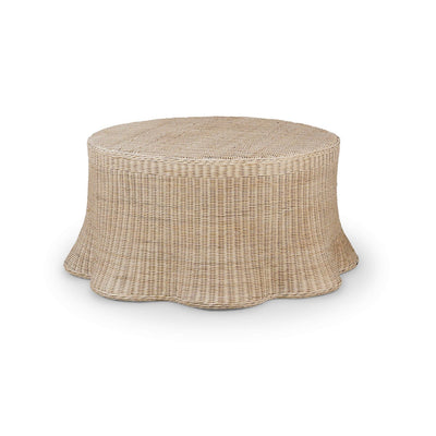 Round rattan coffee table with flared skirt design.