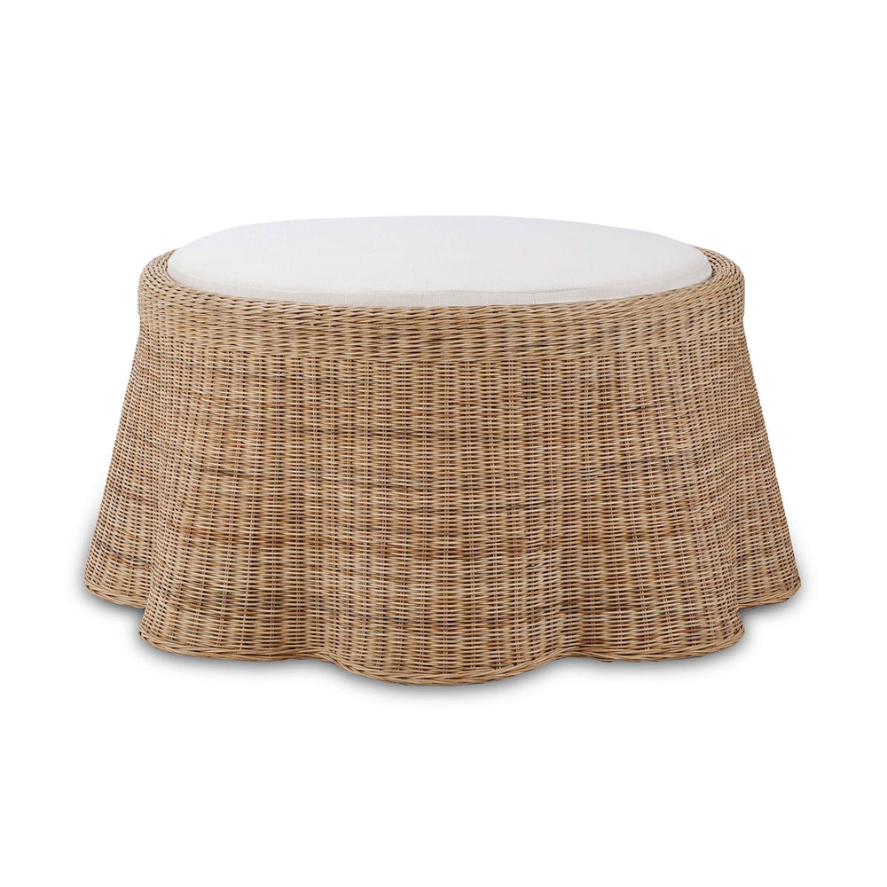 Round rattan ottoman front view with cushion.