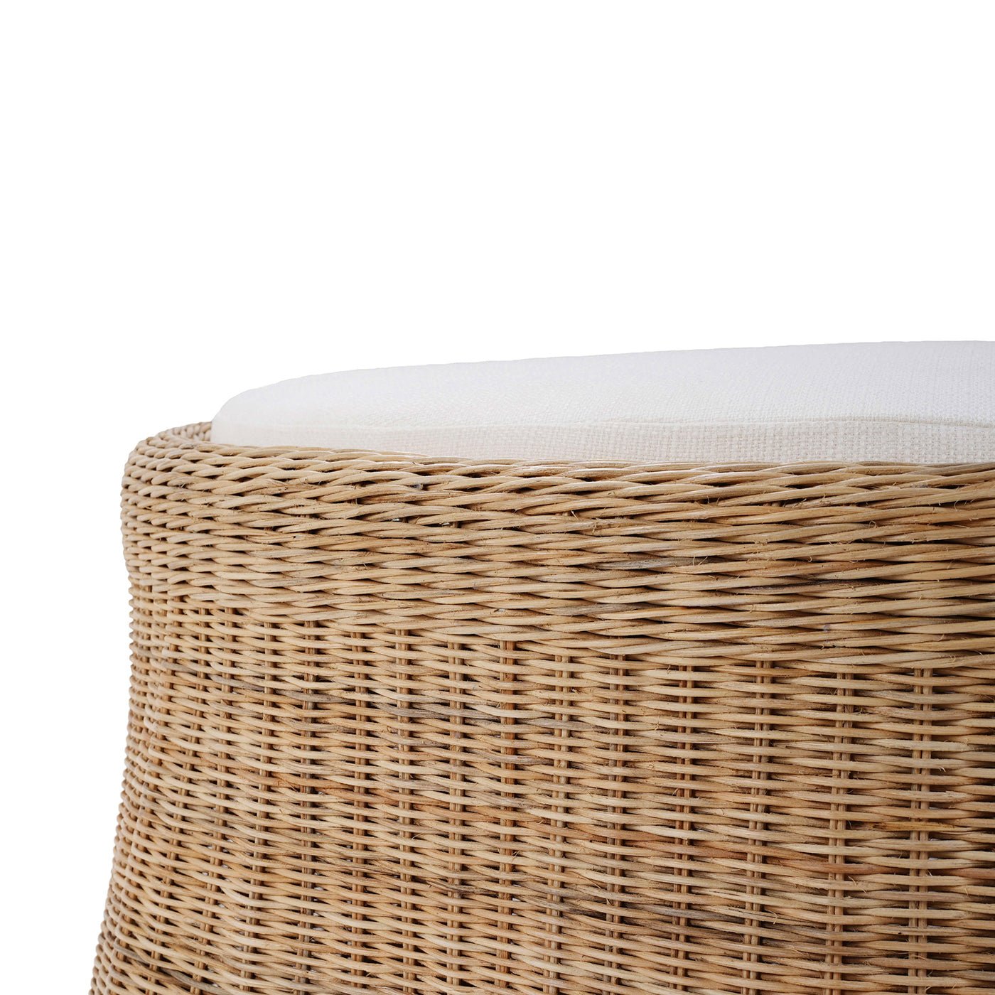 Detailed rattan ottoman weave and cushion edge.