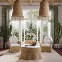 Rattan ottoman in bright room with armchairs.
