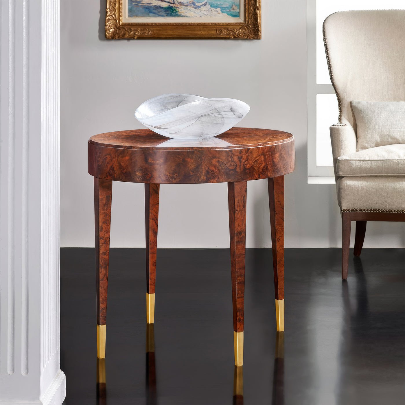Side table in elegant room with decorative marble bowl.