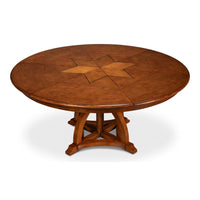 Round walnut dining table with central star pattern.