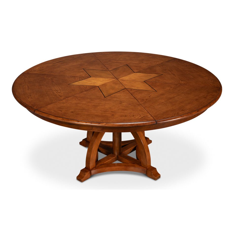 Round walnut dining table with central star pattern.