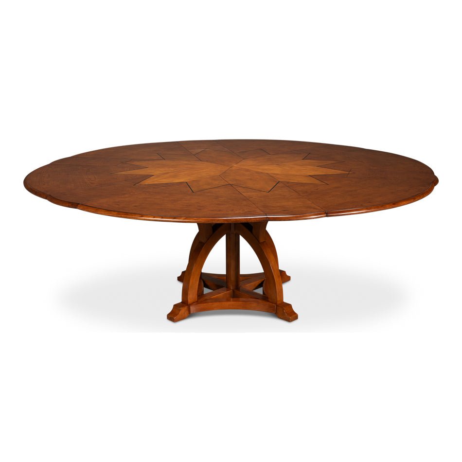 Fully extended round walnut dining table with star pattern.