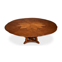 Fully extended round walnut Jupe dining table.