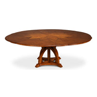Extended round walnut Jupe dining table with pattern.