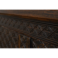 Intricate carving details on Moroccan sideboard panel.