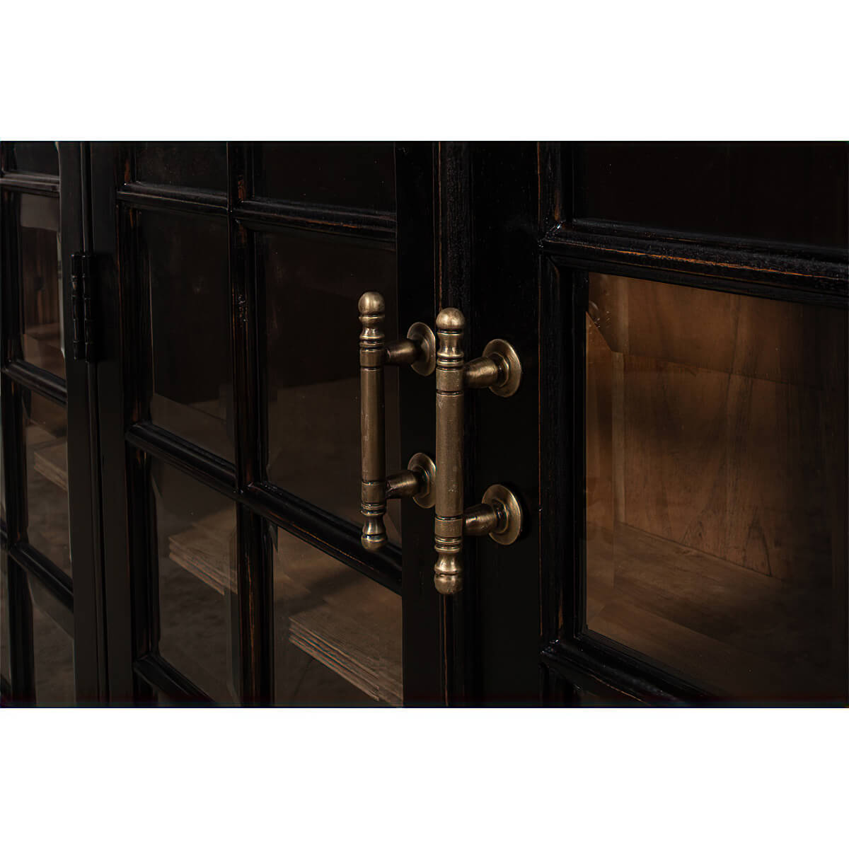Close-up of handles on rustic bookcase doors.