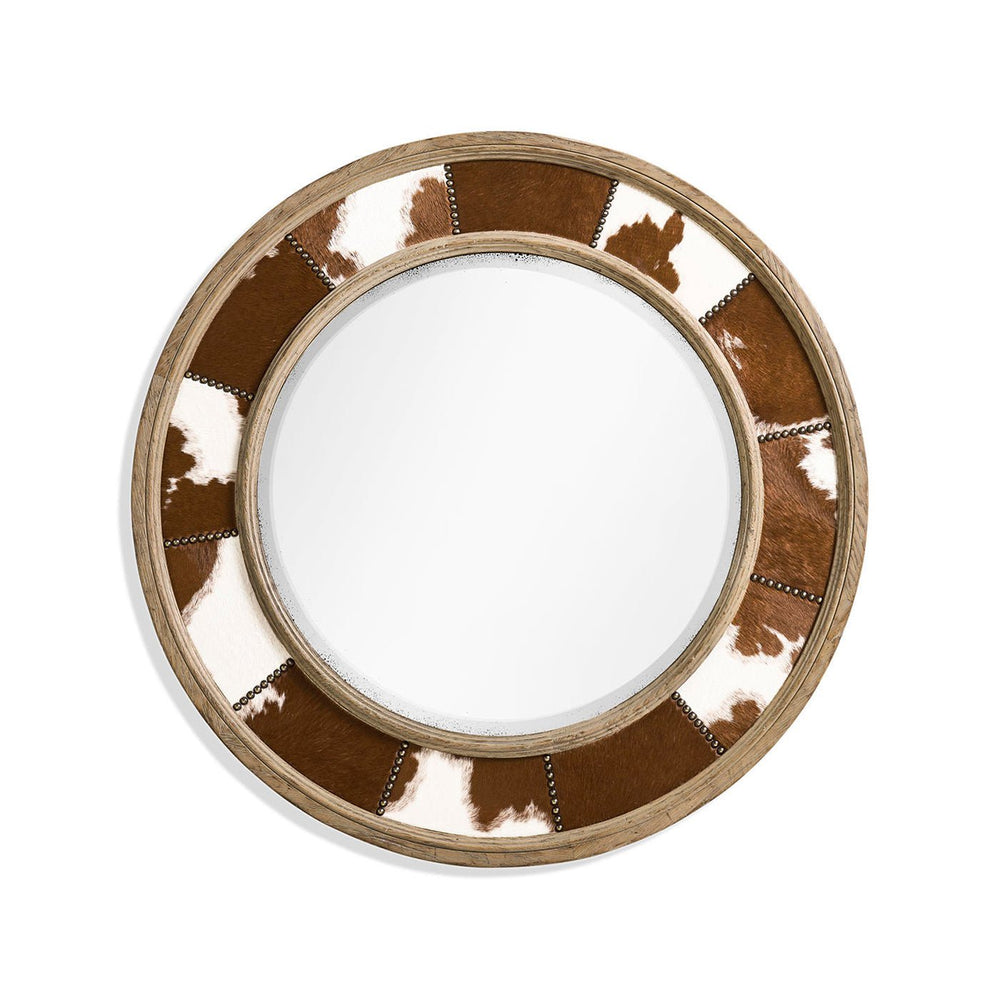 Round mirror with cowhide inlay close-up view.