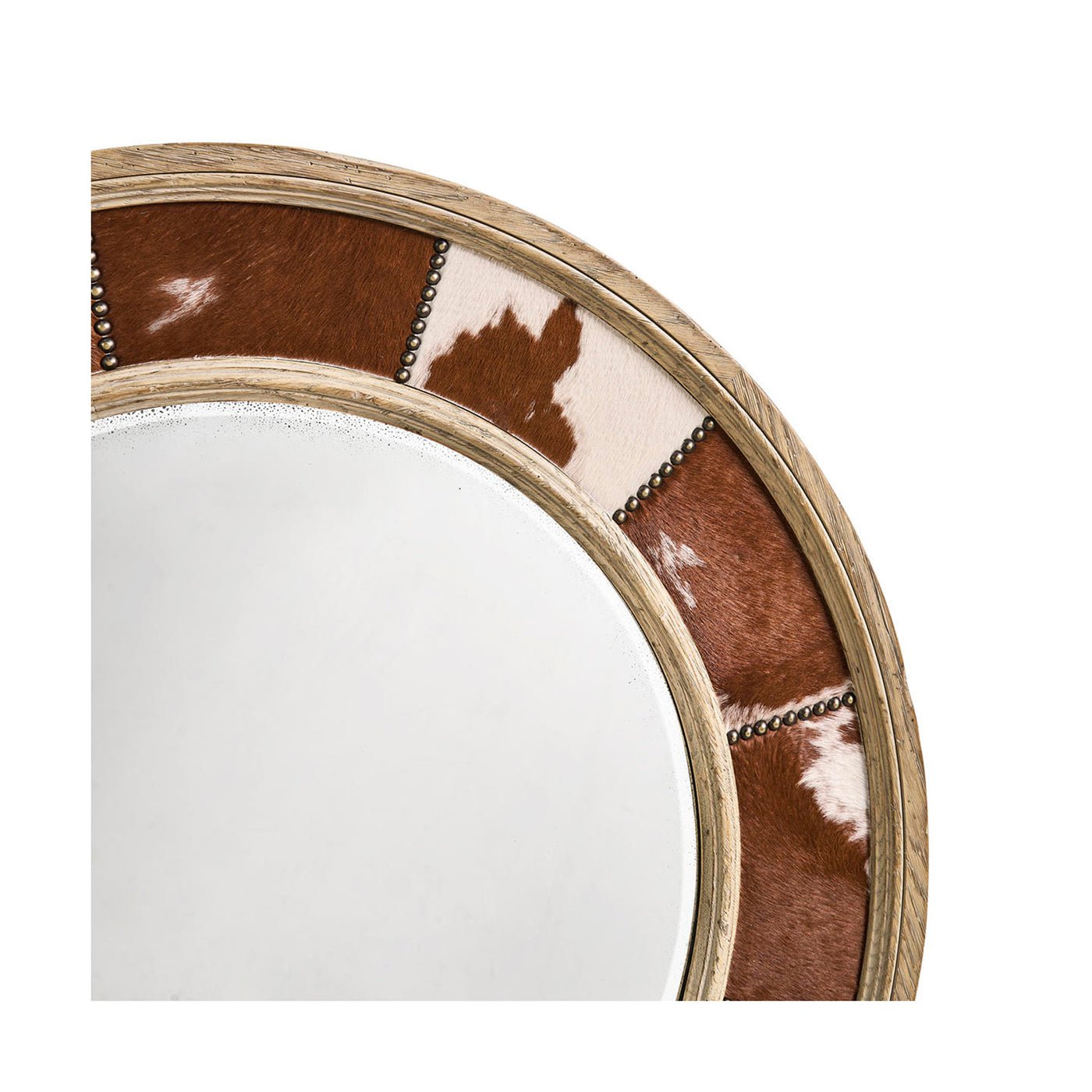 Detailed view of cowhide and nailhead trim on mirror.