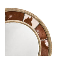 Detailed view of cowhide and nailhead trim on mirror.