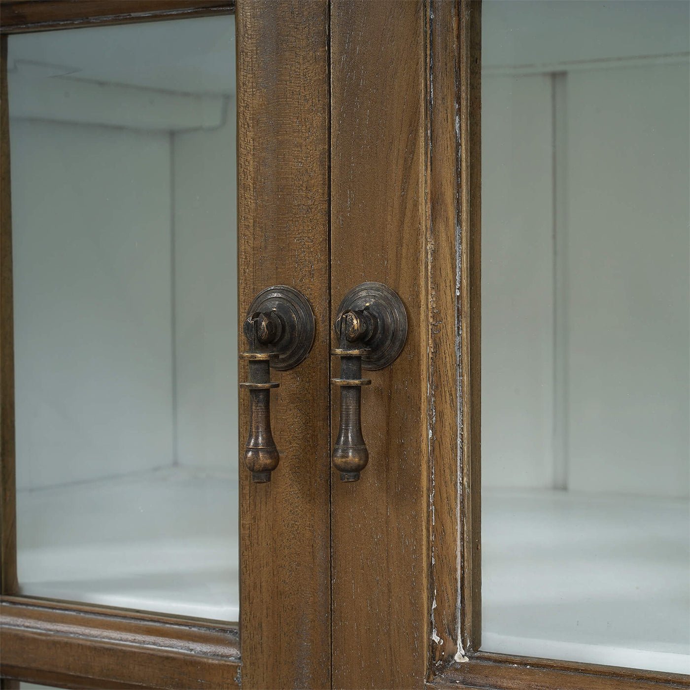 Rustic display cabinet door handles, close-up view.