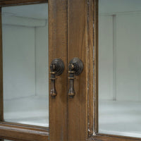 Rustic display cabinet door handles, close-up view.