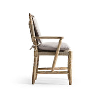 Rustic armchair side view with cushions.