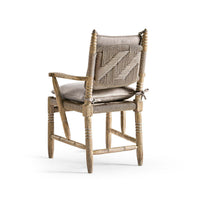 Rustic armchair back view with cushions.