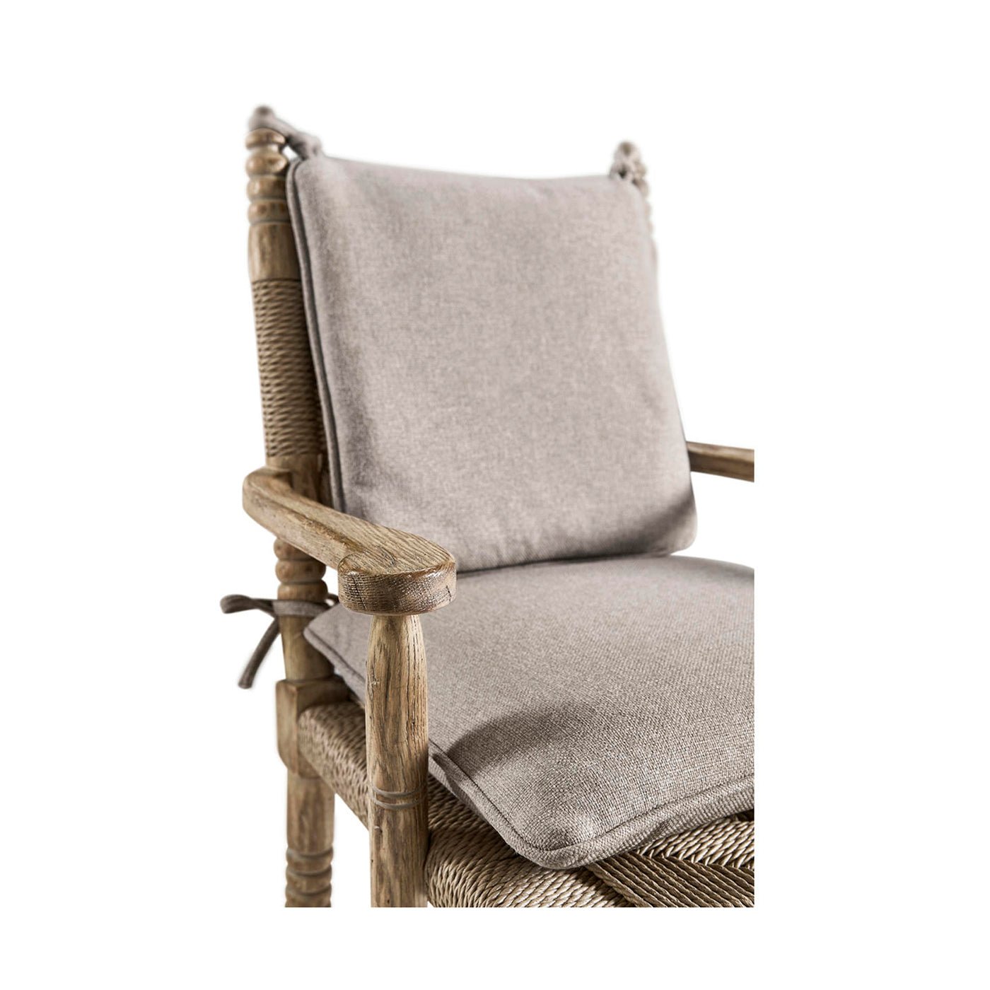 Rustic armchair seat cushion close-up.