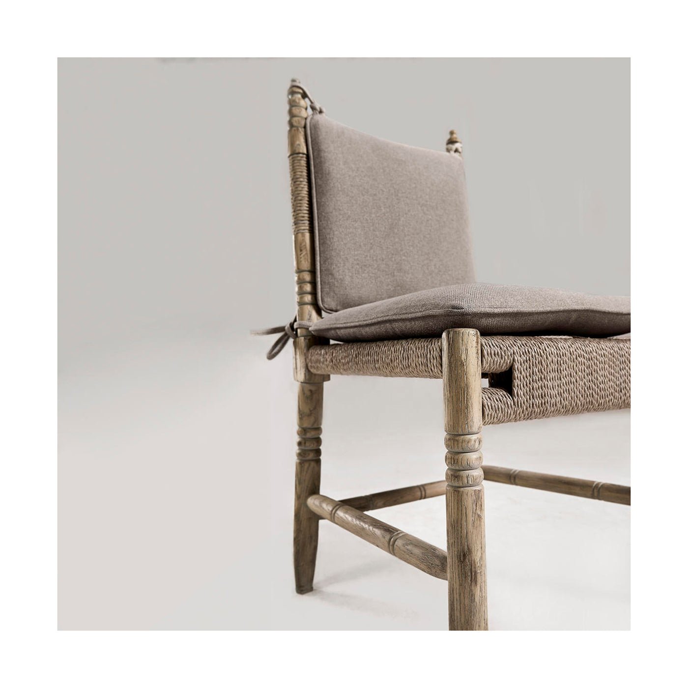 Rustic chair with cushion, angled side view.