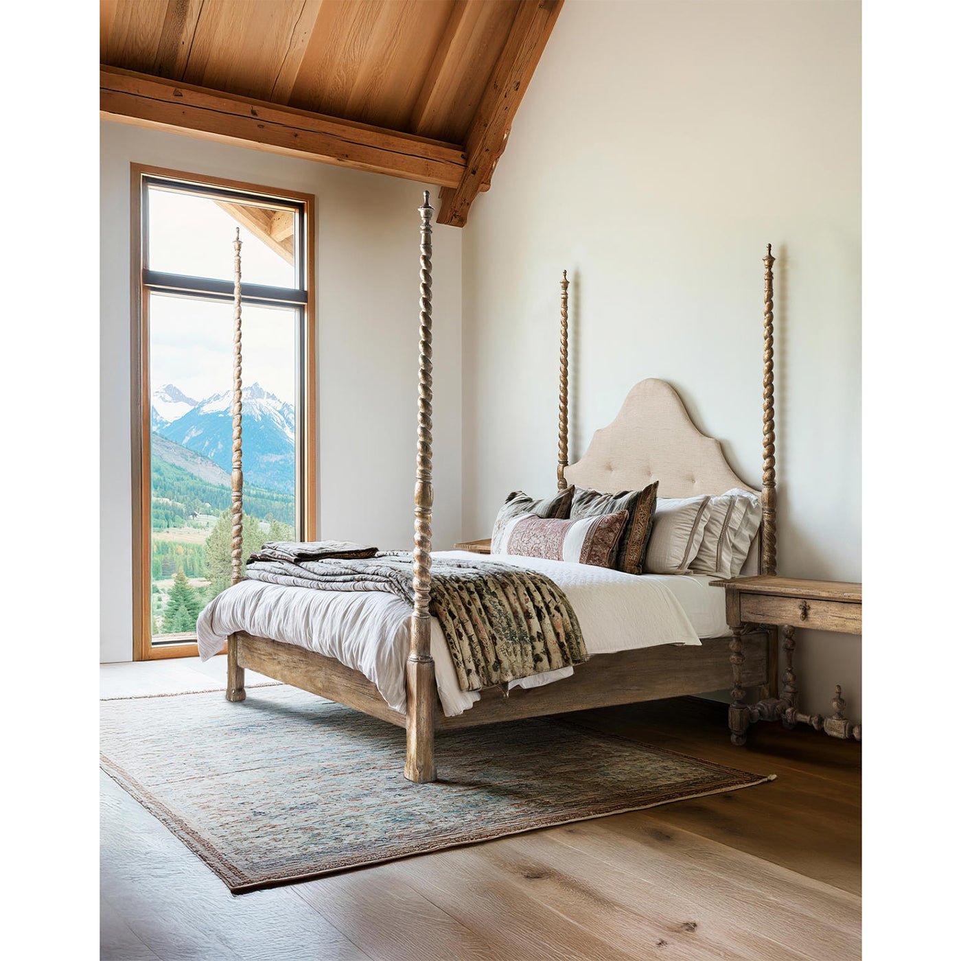 Rustic bed in mountain-view bedroom, side perspective.