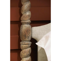 Textured detail of rustic bed post and headboard.