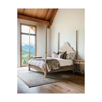 Rustic farmhouse bed in cozy room setting.