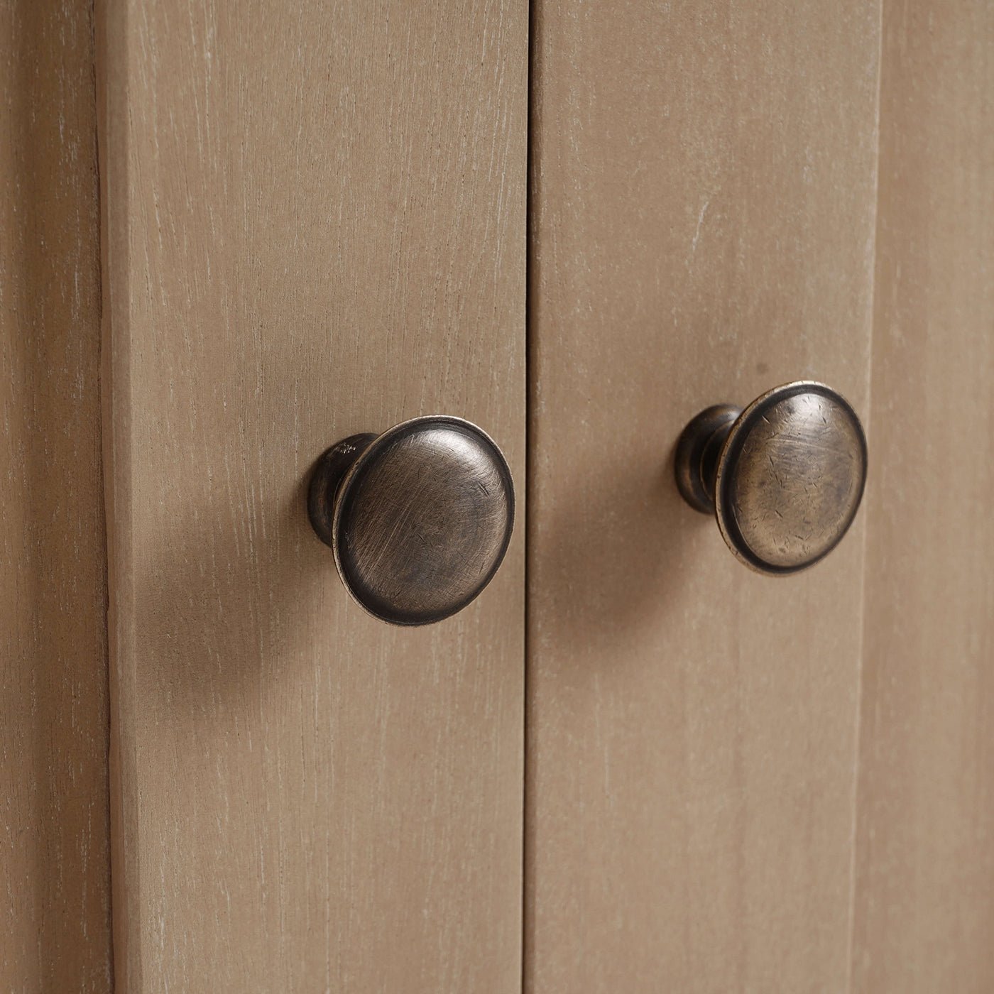 Rustic farmhouse side cabinet door knobs close-up.
