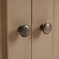 Rustic farmhouse side cabinet door knobs close-up.