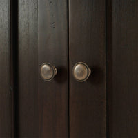 Cabinet door knobs close-up, rustic design, walnut finish.