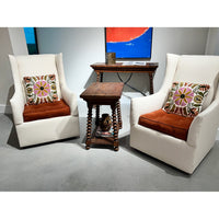 End table in living room setup with armchairs.