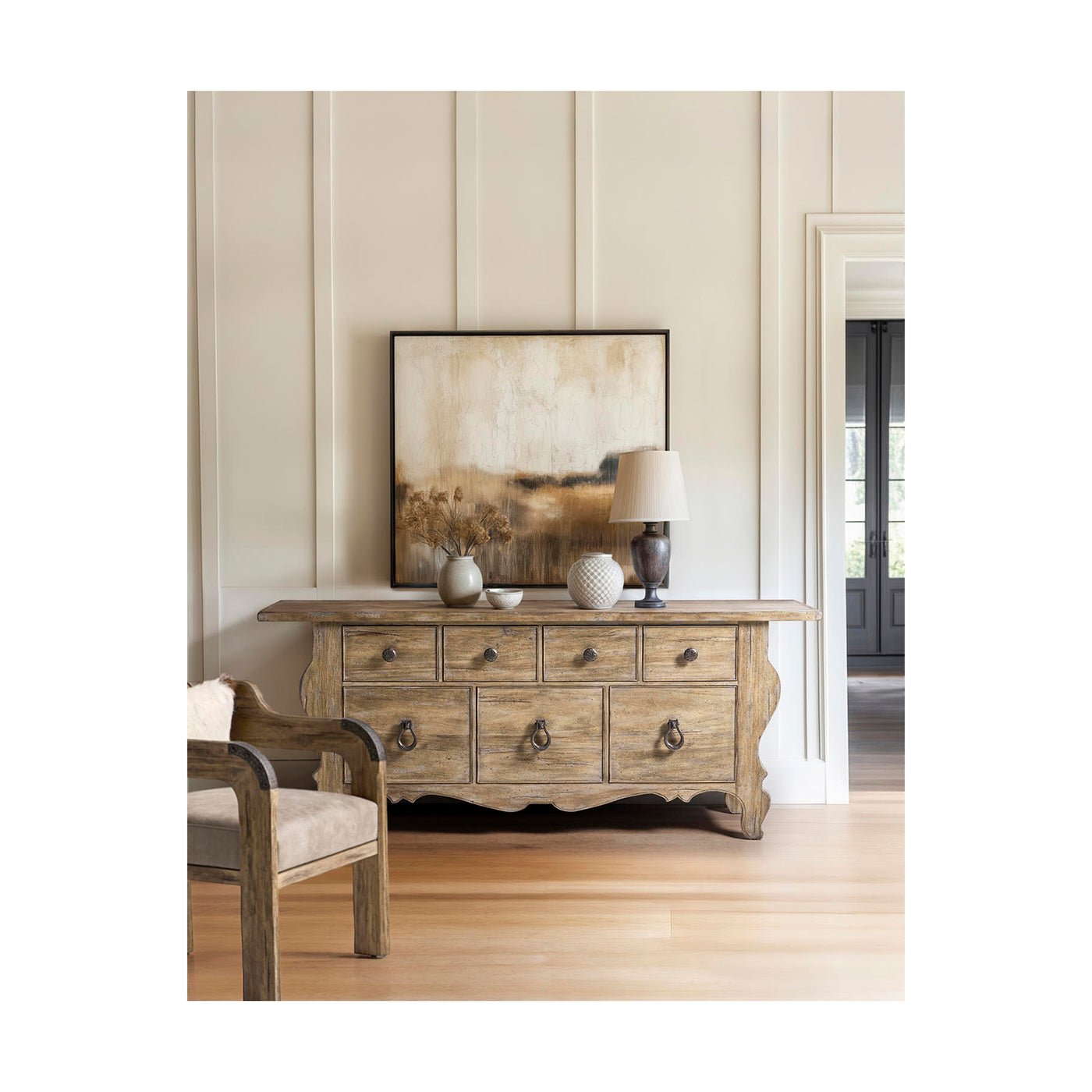 Rustic dresser styled in room with art and decor.