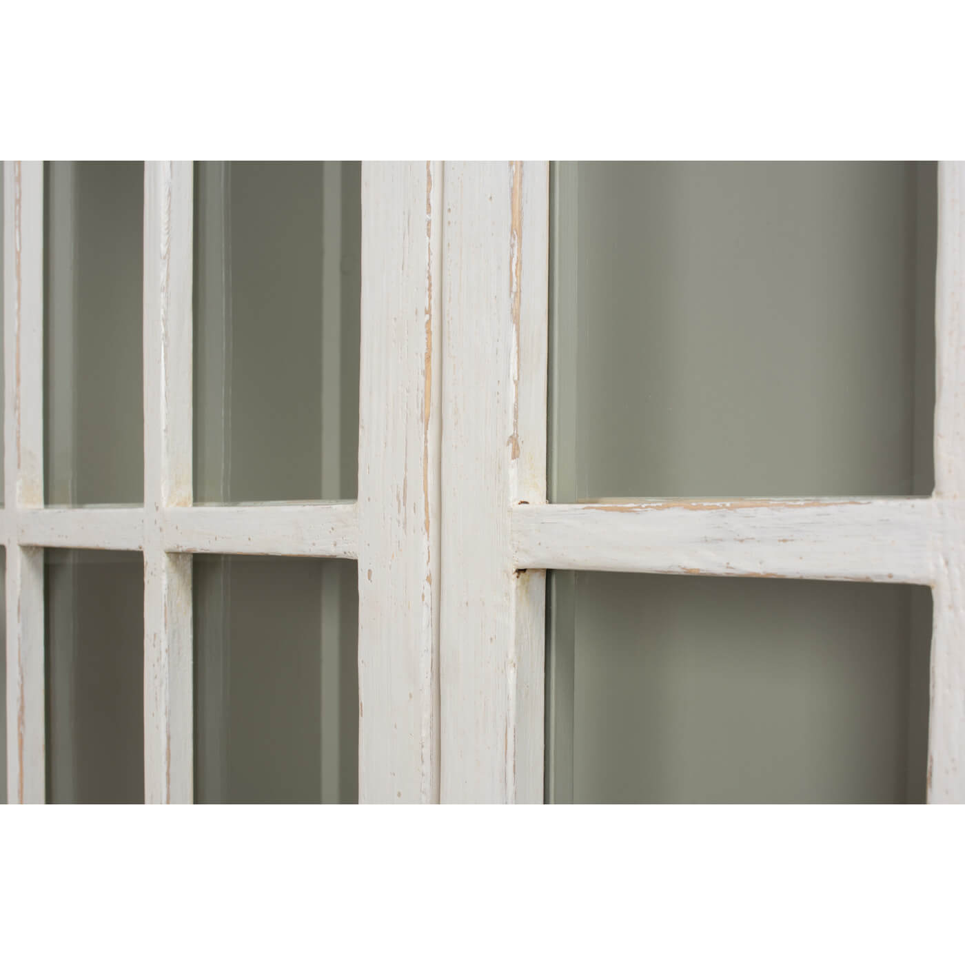 Rustic whitewashed bookcase, close-up window panel detail.