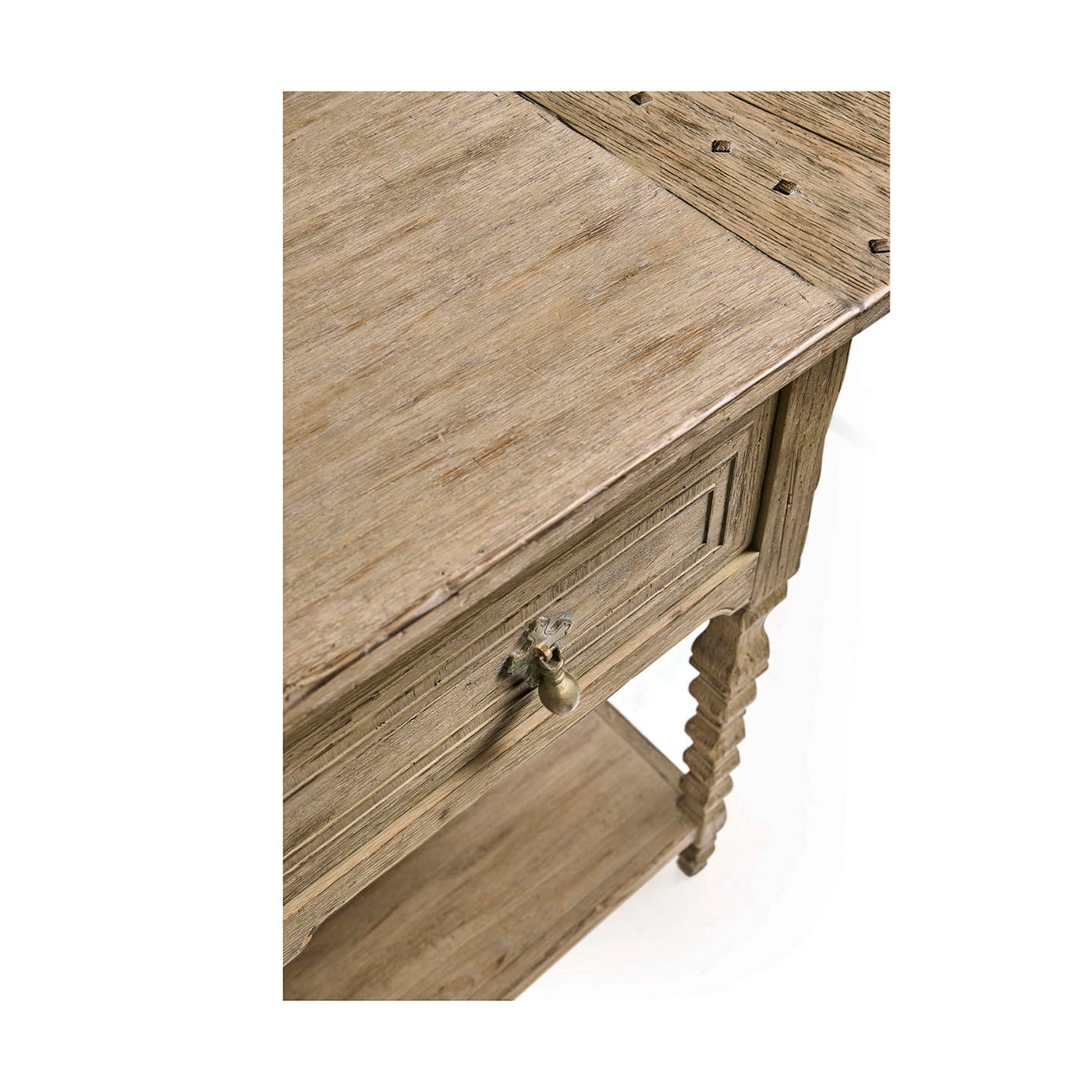 Corner detail of console table, surface and drawer handles.