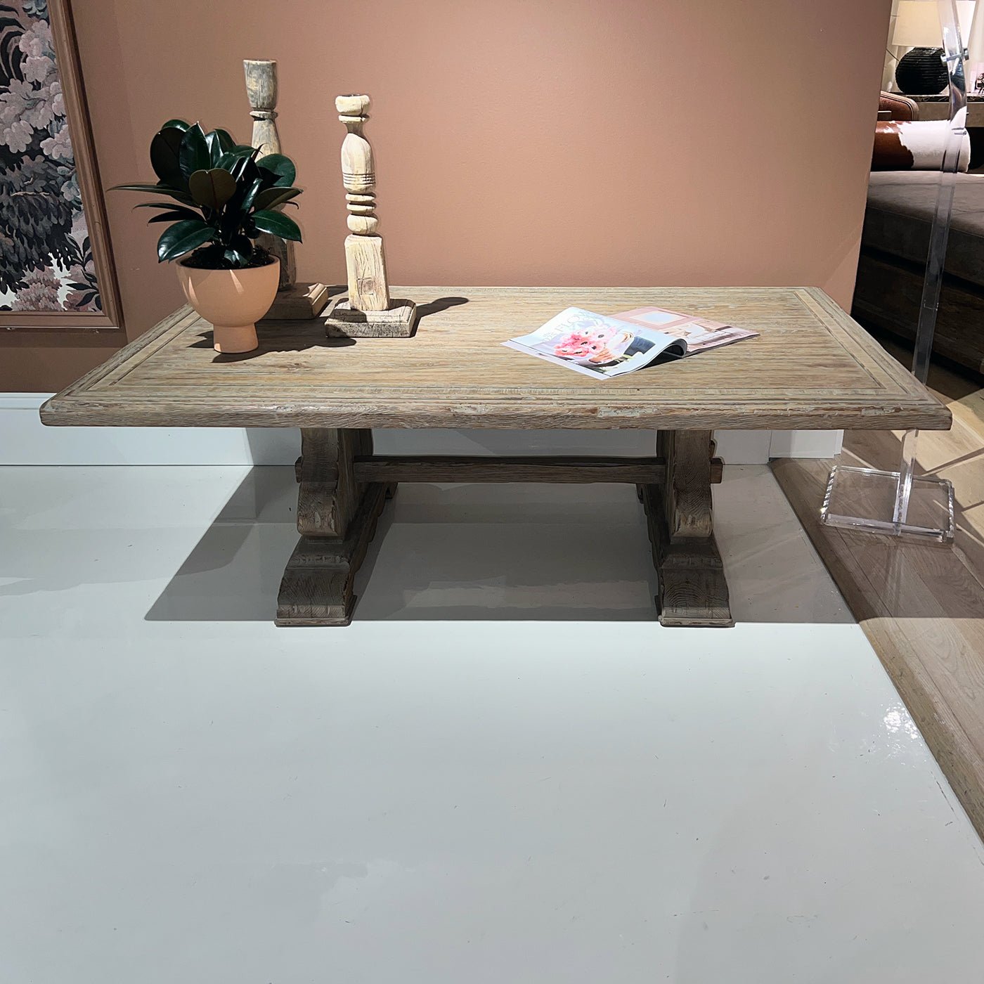 Rustic trestle coffee table with decor items in display
