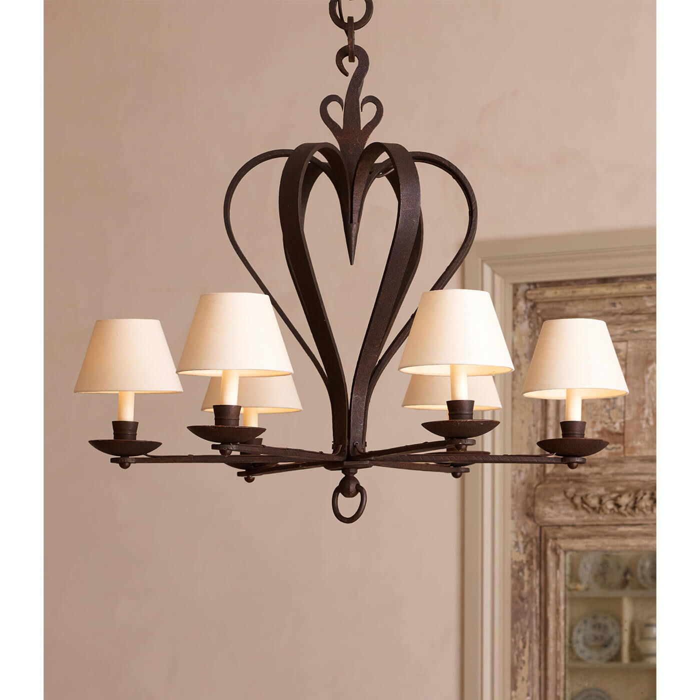 Rustic chandelier with cream shades, classic French style.