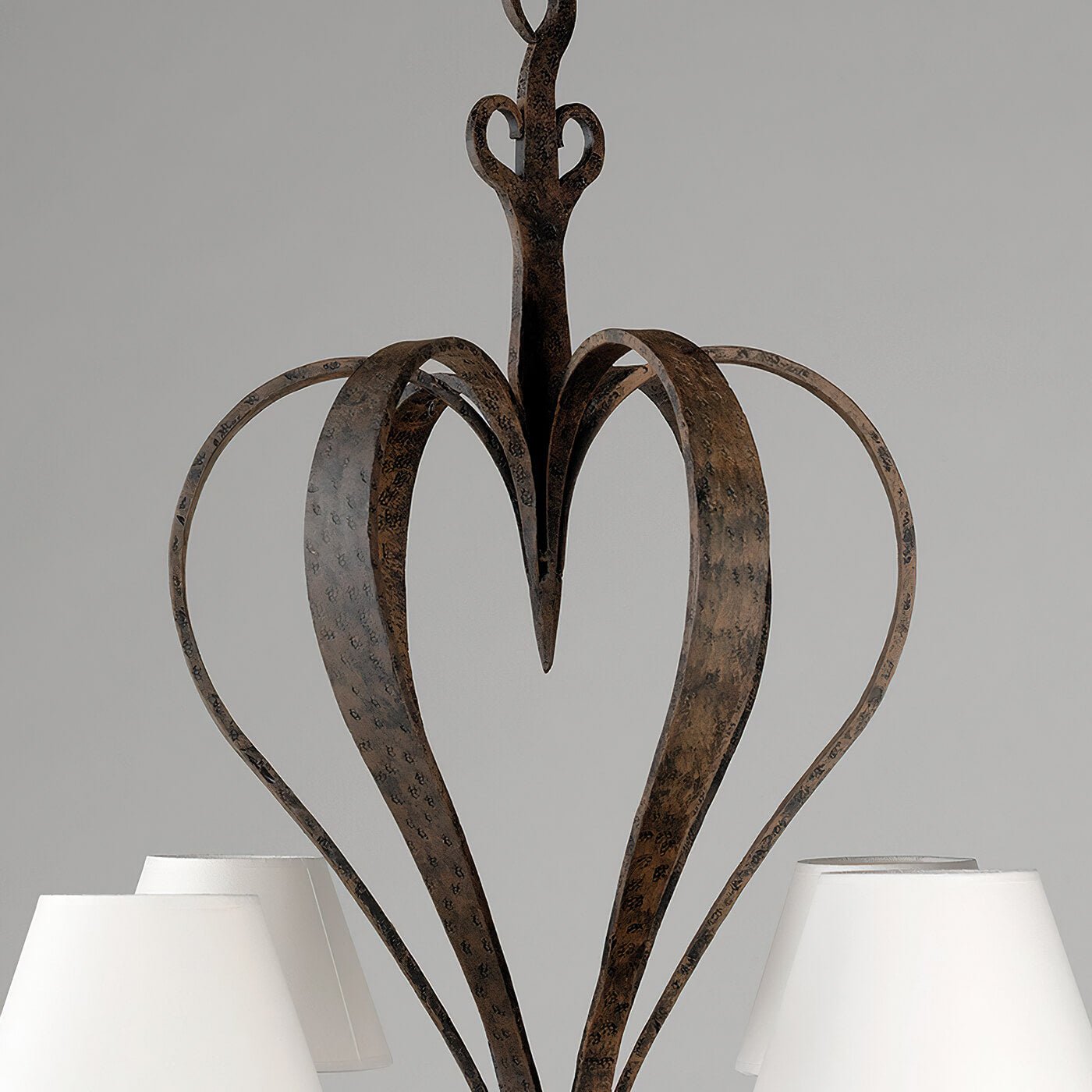 Detailed view of chandelier top, iron heart design.
