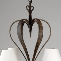 Detailed view of chandelier top, iron heart design.