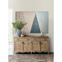 Sideboard in room with abstract artwork above.