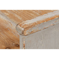Rustic gray bench, close-up, detailed corner finish.