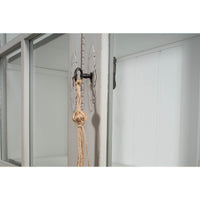 Close-up of latch on rustic grey painted bookcase upper door