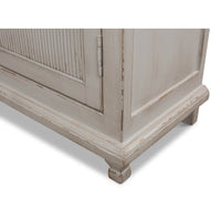 Bottom corner close-up of rustic grey painted bookcase